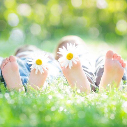 zwei Partner liegen glücklich im Grass und fühlen sich wohl gemeinsam können Sie durch die Ehetherapie Darmstadt Krisen bewältigen und zu Glück finden